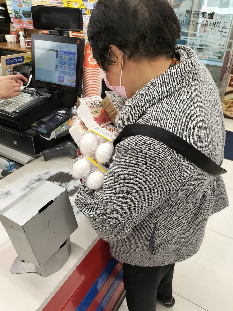 婦人拿走最後的兩盒蛋，心情大好。翻攝自蘇一峰臉書