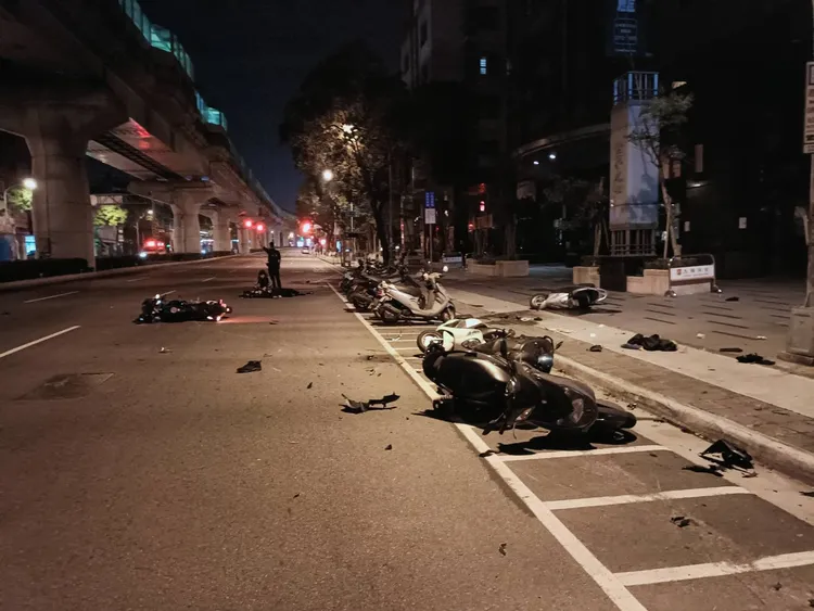 事故現場多輛機車被撞倒，零件四散。讀者提供