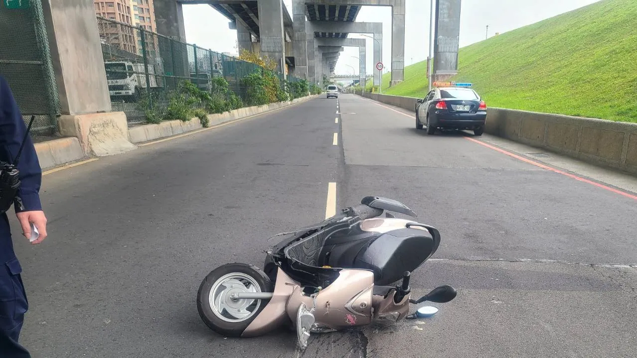 辜女騎乘的機車倒在地上。三重警分局提供