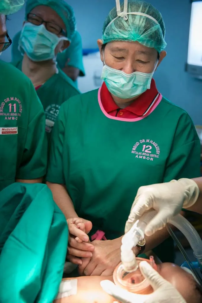 2016年關皚麗醫師用自己的手溫暖手術中的病童。高醫提供