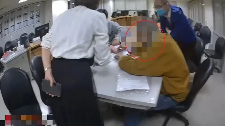 警方獲報趕抵工務局，邱男(紅圈處)則坐在椅子上。海山警分局提供