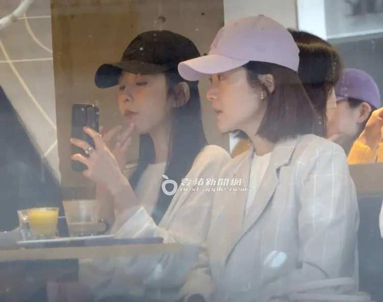 邵雨薇（左）用手機充當鏡子看臉上的痘痘。特勤中心攝