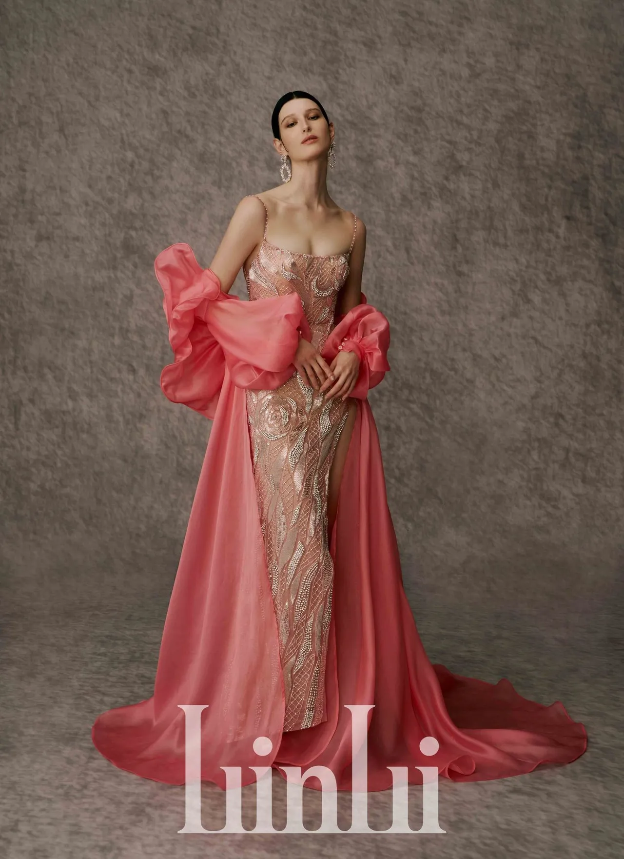 白标系列手工珠绣细肩带高衩洋装，合臀窄摆高衩的裙型能修饰下身线条，不同层次的粉网配上银色系珠缝，运用施华洛世奇水晶缝制出立体手绘玫瑰图腾，配衬真丝乌干纱披肩外套，优雅又显气韵。品牌提供