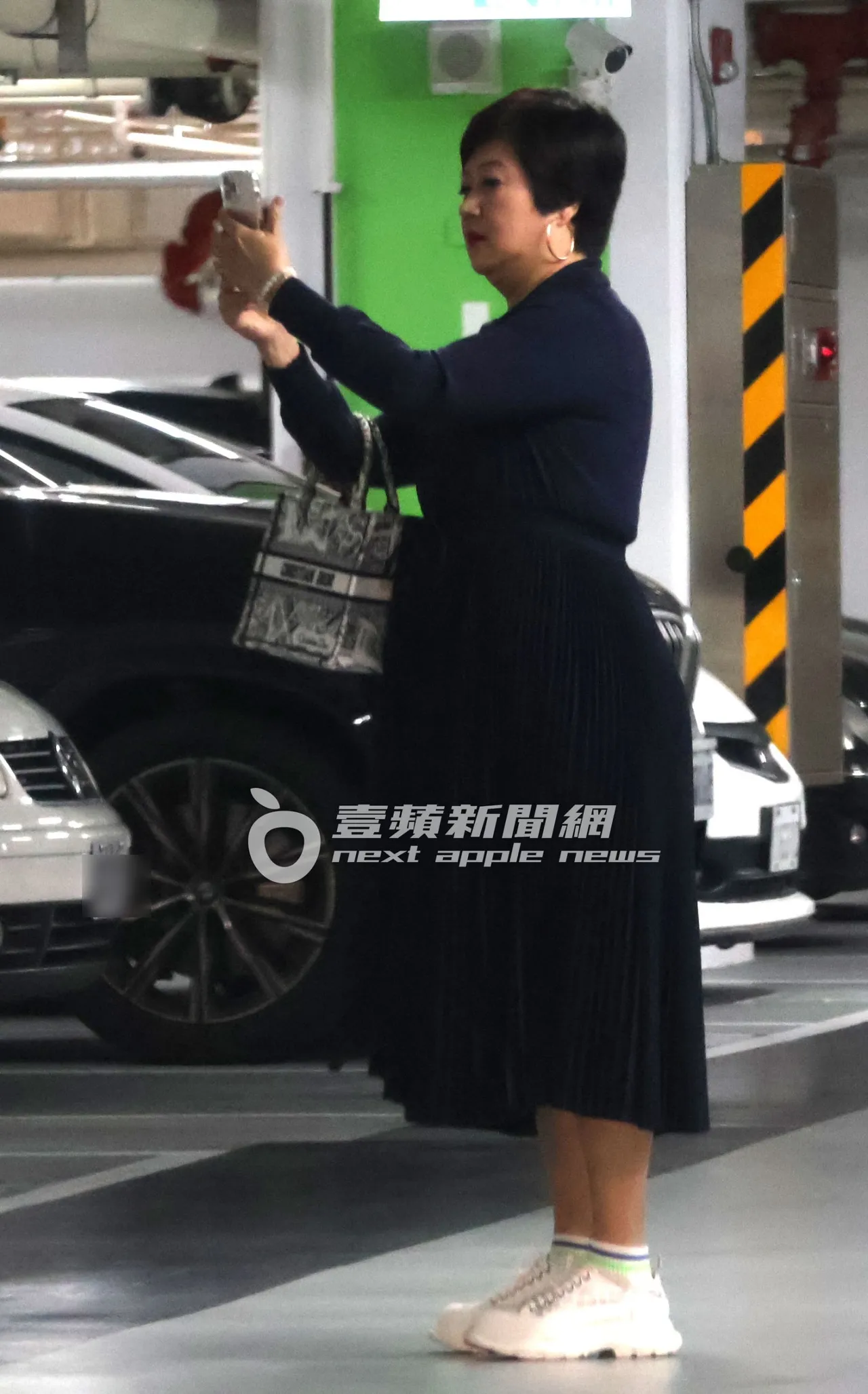 崔佩儀手勾CHRISTIAN DIOR名牌包,拍下停車格號碼,深怕忘記車停哪裡。特勤中心攝