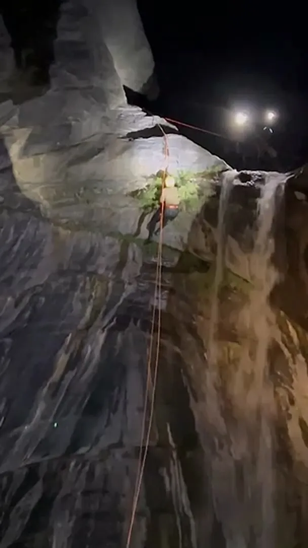 特搜大隊小隊長洪伯軒先以繩索上登的方式至瀑布上方。 翻攝畫面