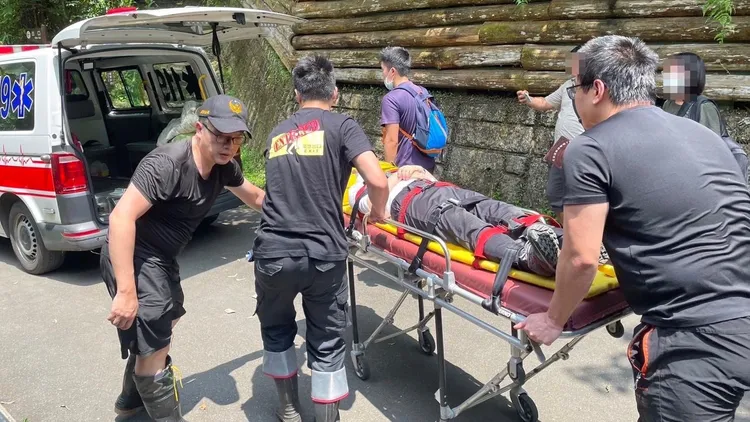 救護人員將陳婦送上救護車。新北市消防局提供