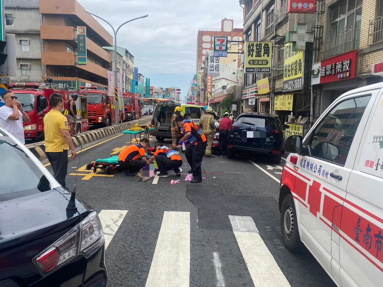 警消到場架高休旅車,救出捲入車底的婦人。讀者提供