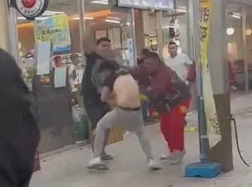 陣頭眾人拉住黑衣男上衣，讓他無法脫身。翻攝自臉書「爆料公社」