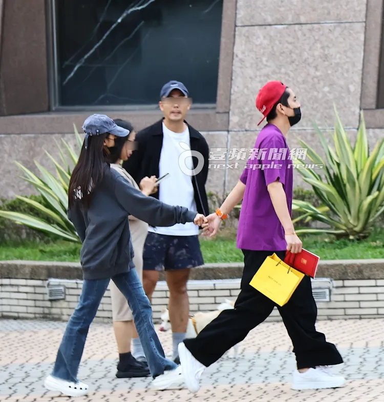 蔡卓宜（左）勾著王大陸的小指，走在後方，畫面充滿粉紅泡泡。特勤中心攝