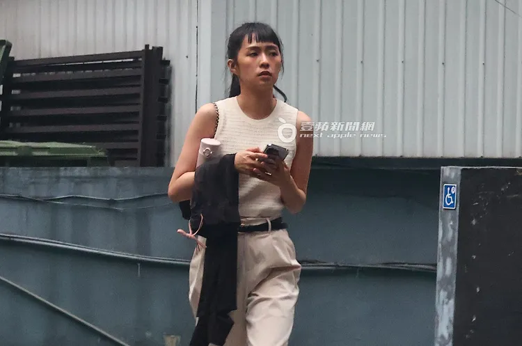 疑似心事重重的簡廷芮，拿著手機向遠方望去。特勤中心攝