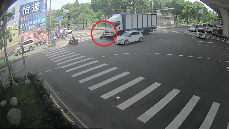 機車與大貨車越靠越近，最後遭大貨車右側車頭擦撞後倒地。民眾提供