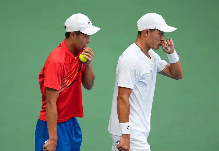 許育修（右）、黃琮豪比賽間商討戰術。新華社