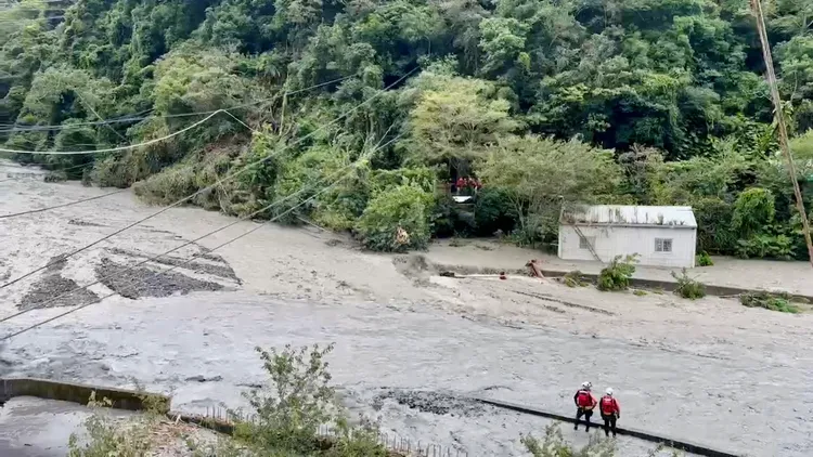 搜救人員在現場架設繩索系統，橫跨40多米河道。台中消防局提供