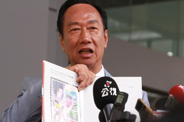 郭台銘大方跟媒體分享麻生送的集郵冊內容。讀者提供