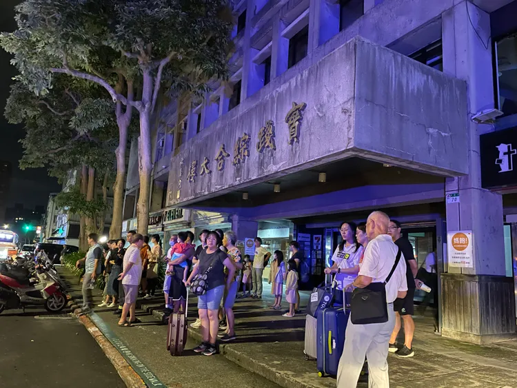 撤離民眾在實踐大學門口等候。彭欣偉攝