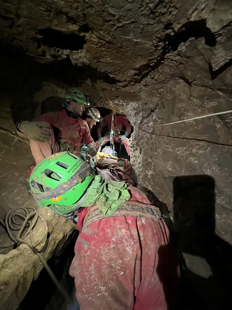 救援團隊接力把狄基從狹窄地洞中運出。路透社