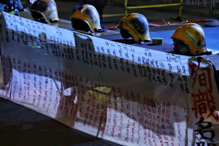 消促會拉起寫著近10年43位殉職消防員姓名的布條。林林攝