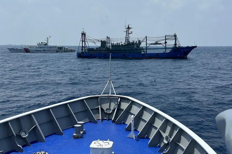 中國海警船（左）與海上民兵船（右），阻止菲律賓海巡艇「斯丹崗號」接近仁愛暗沙。美聯社