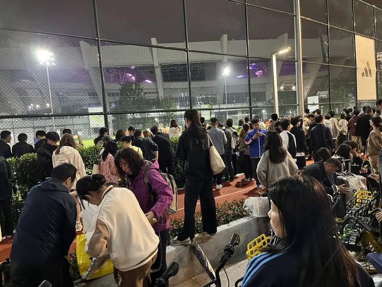 未能搶購到票的歌迷聚集場外，透過表演場地溢出的音樂、燈光沾染一絲演唱會氛圍。圖攝於10月13日。中央社