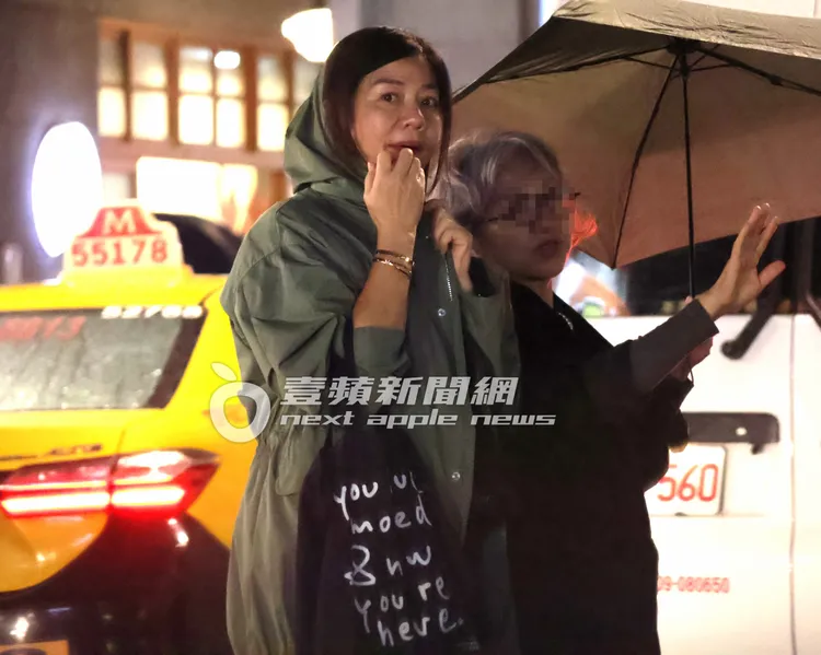 鍾楚紅（左）與友人撐傘逛迪化街商圈。特勤中心攝