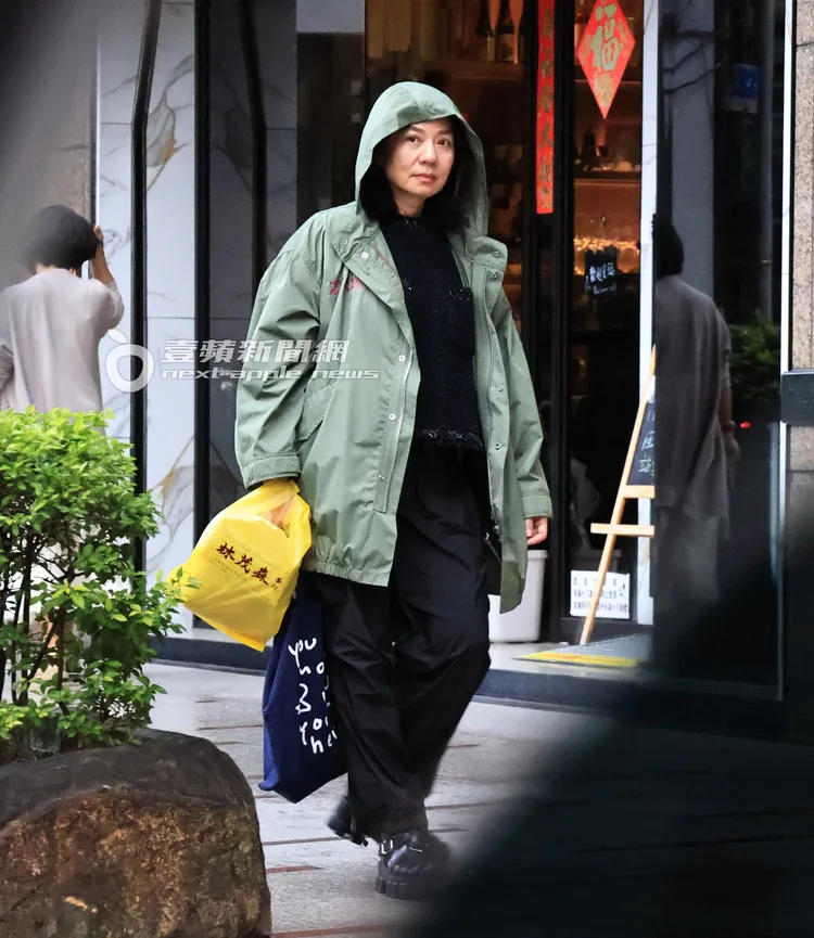 天空飄起綿綿細雨，鍾楚紅將外套帽子戴起，提著一袋茶葉。特勤中心攝