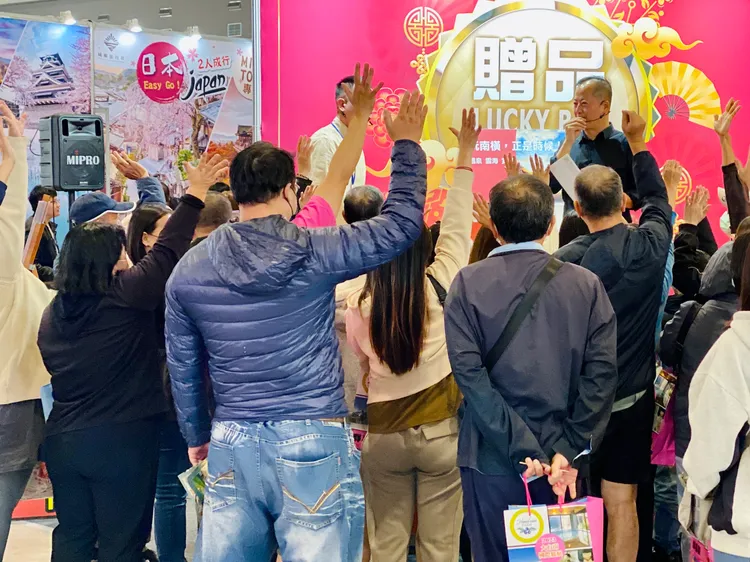 民眾圍觀舉手搶好康。王志弘攝