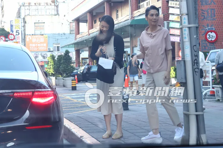 賴佩霞（右）身穿粉色系圓領襯衫、搭配淺色西裝褲及白色鞋子，整體造型簡單優雅。特勤中心攝