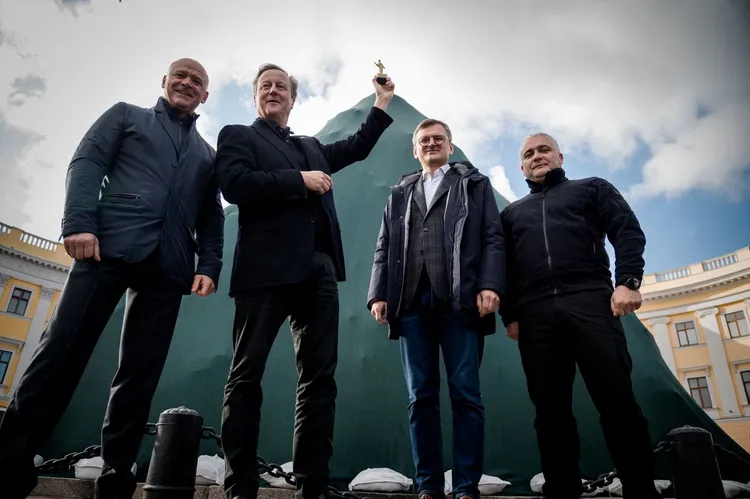 卡麥隆(左二)到黑海邊的敖德薩市訪問，他手中高舉的是敖德薩建城者黎希留公爵的雕像。路透社