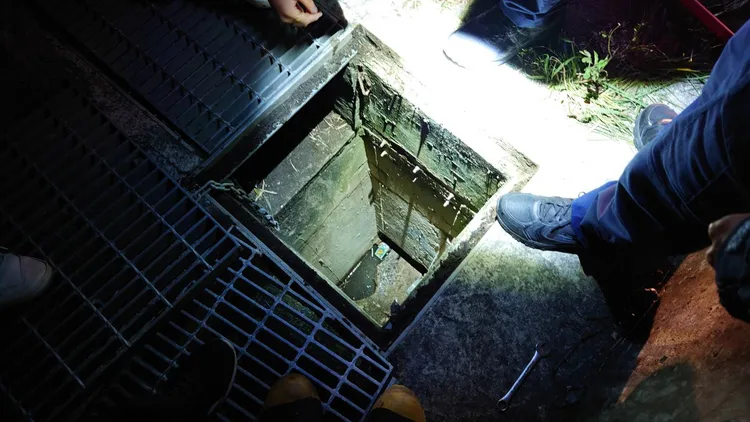 男子騎機車時口袋剛買的手機滑出掉落水溝，人跳下去撿手機卻受困。翻攝畫面