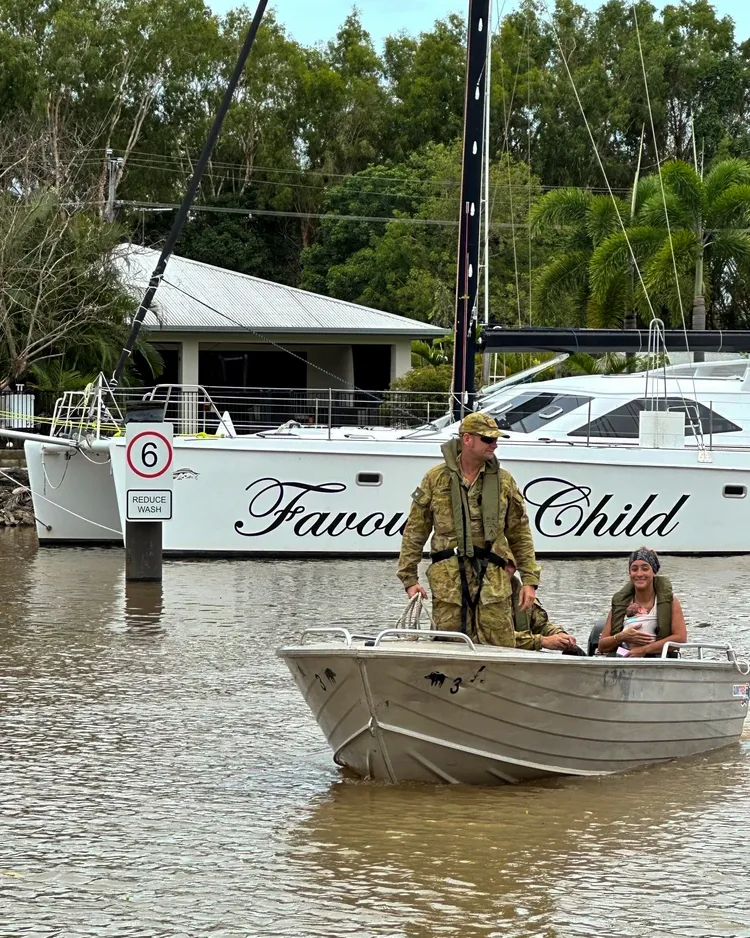軍方協助一名母親和襁褓中的嬰兒撤離凱恩斯。美聯社
