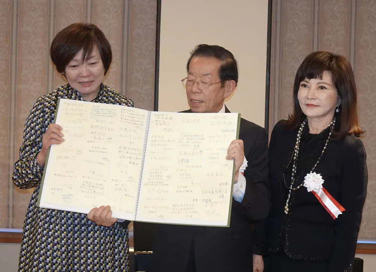 台灣藝術家邱貴（右1）正在東京舉辦畫展，8日由駐日代表謝長廷將她的一副畫作贈給日本前首相安倍晉三遺孀安倍昭惠（左1），也把她在台灣主辦安倍晉三影像展時觀眾留言便籤集成冊，贈給安倍昭惠。中央社