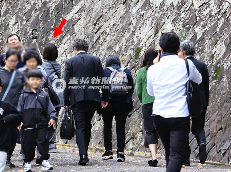 準備入園的酒井法子（紅箭處）將自拍桿拿高，與同行友人開心自拍。特勤中心攝