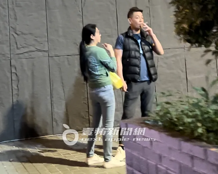 張碩文（右）與「緊緻女」在火鍋店外抽飯後菸。特勤中心攝