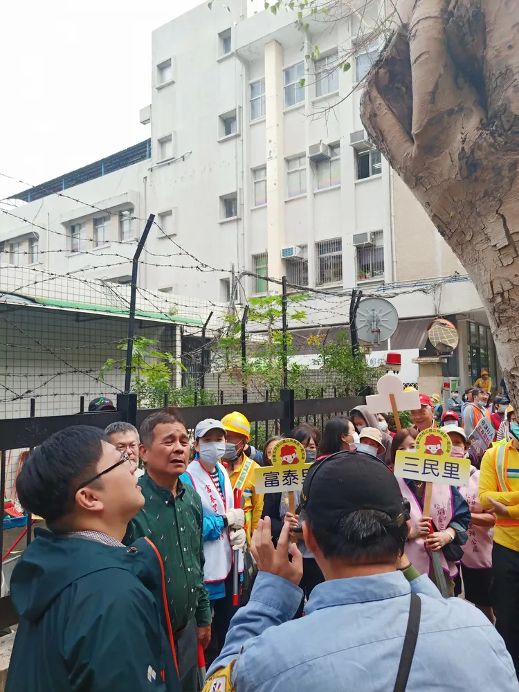 里民、環保志義工及清潔隊，跟著徐世勳巡查樹洞有無積水。環保局提供