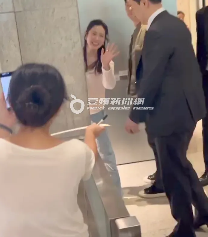 孫藝真走進台北101員工閘門後，突然回頭與沿路上的熱情粉絲打招呼，笑容滿面。特勤中心攝