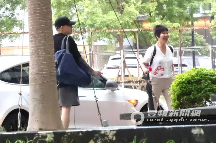 Toyz（左）背著大袋行李邊抽菸，跟媽媽一起步出篠崎泫香閨。特勤中心攝