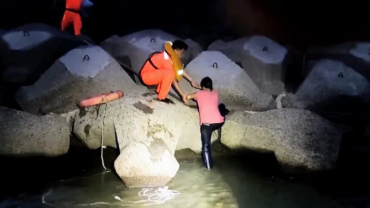 安檢人員以救生圈搭配浮水繩，順利將落海者拉上岸。海巡署提供