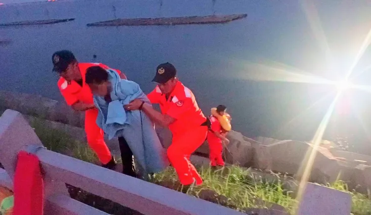 婦人落海輕微失溫，安檢人員貼心裹上毛巾。海巡署提供