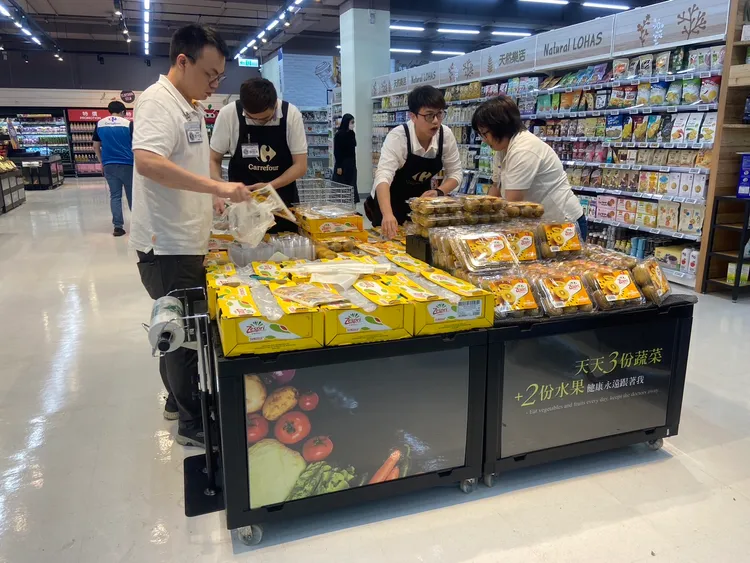 家樂福中原店重新開幕期間推出不少優惠活動，廠商忙著布置補貨。業者提供