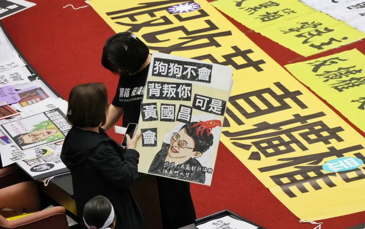 綠委將抗議民眾的創意標語，拿進立院揶揄民眾黨團總召黃國昌。莊宗達攝