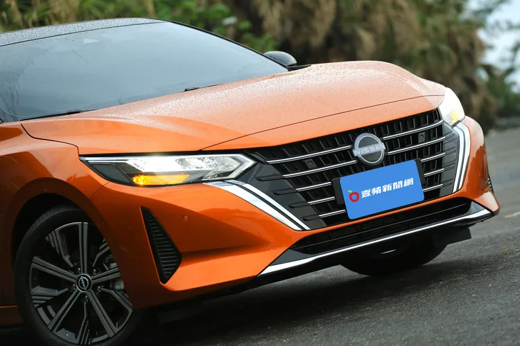 NISSAN ALL NEW SENTRA視覺重點再強化，水箱護罩V字形鍍鉻飾條向左右再橫移延伸，並且將中央原先的網格設計改為水平線條讓整體車頭視覺顯得更精緻霸氣。林浩昇攝
