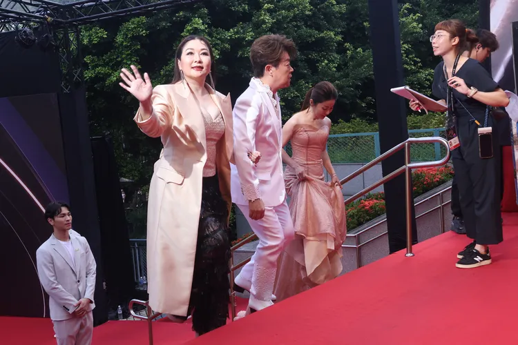 張秀卿爬樓梯不忘打招呼。彭欣偉攝