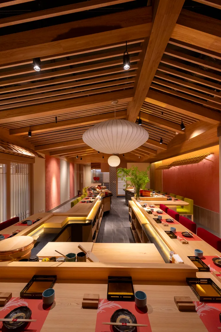 走進米匠華山店，目光立即被沈靜優雅的現代京都風空間吸引，天花板壯觀的椽樑、散發柔光的Herman Miller吊燈和大膽的京都甚三紅色土牆令人印象深刻。業者提供