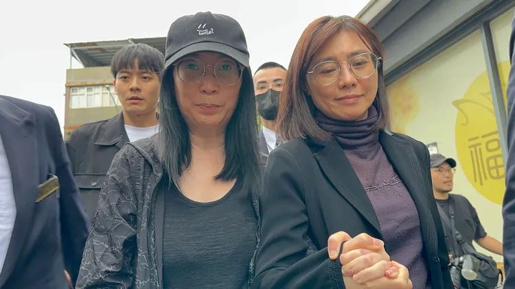 黃嘉千與律師賴芳玉牽手離開。特勤中心攝