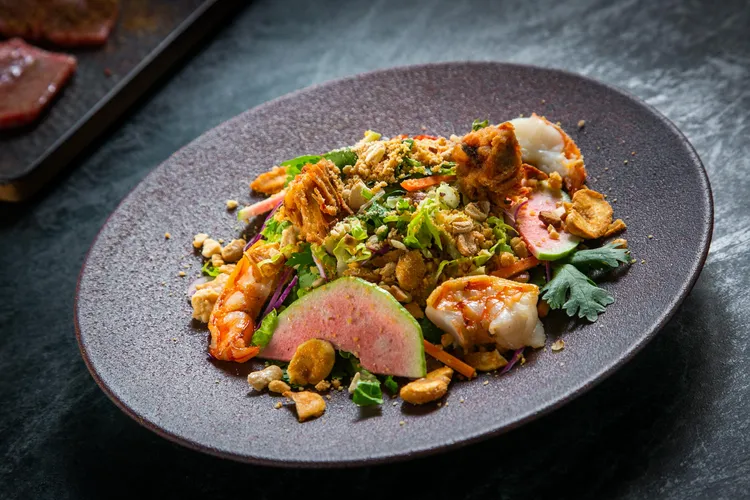 CNX清邁泰北沙拉將羅望子油醋、海蝦，以及堅果和水果的豐富質地相互交織，一口吃下，體驗到令人驚艷的豐富層次。業者提供