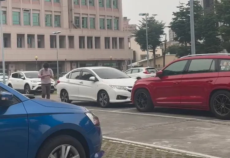 黃郁曉低頭滑手機，如一般人行走。投訴人提供