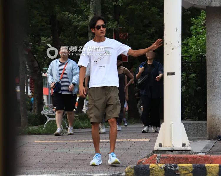 唐治平走回停車場，等紅綠燈時伸手準備扶在電線桿上。特勤中心攝