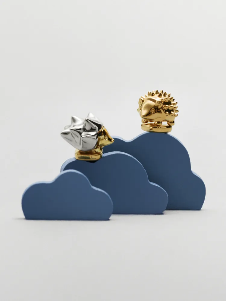 包款上有一對小巧可愛的金屬刺蝟別針。品牌提供