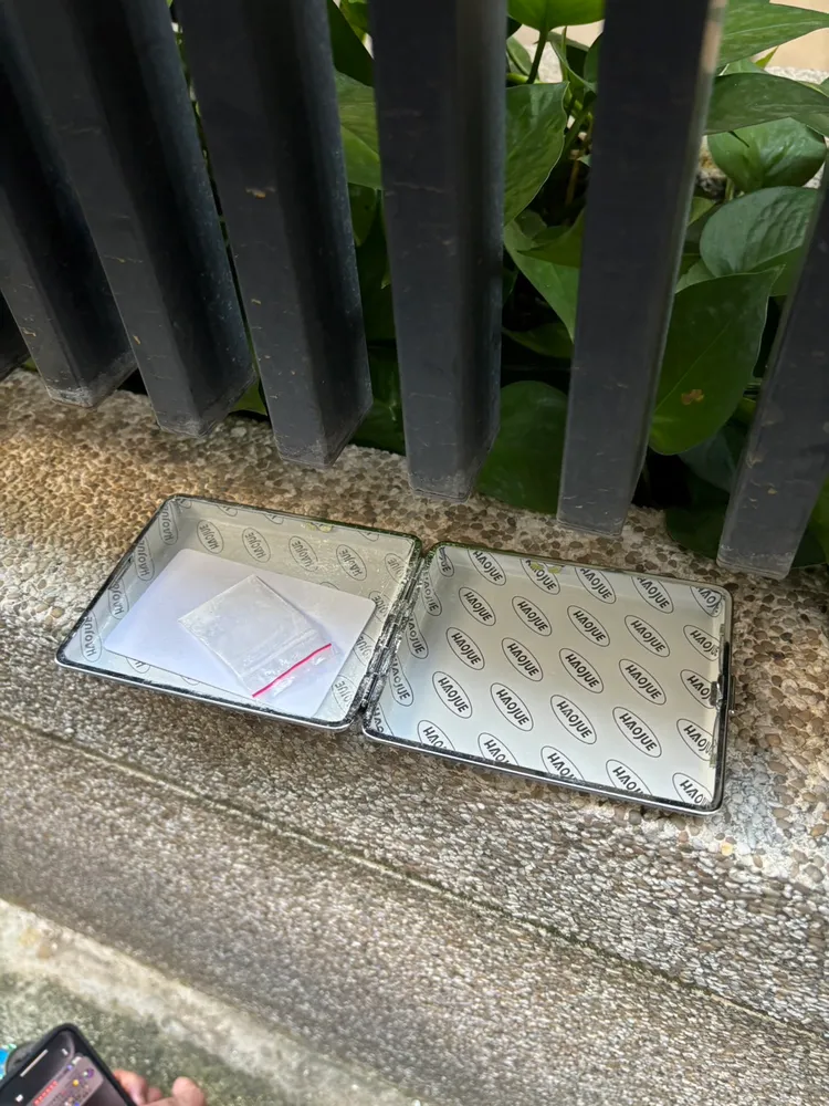 林嫌將吸毒用的K盤丟向車道花圃。民眾提供