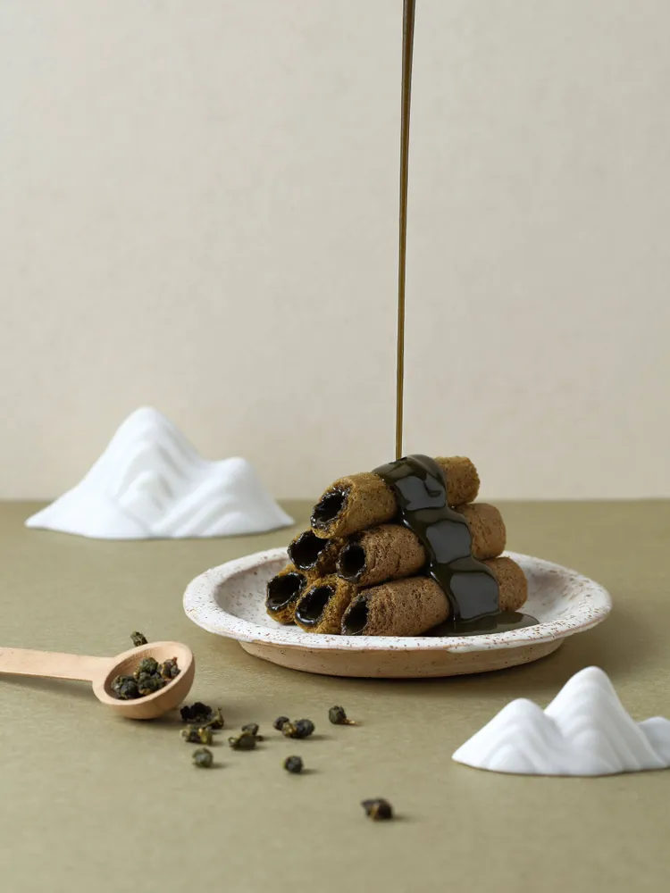 青鳥旅行6月推出全新口味「阿里山烏龍蛋捲」，茶香層次豐富，餅皮酥脆，內餡滑順。業者提供